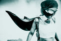 Person wearing a mask and cape in a superhero pose against a light background. burningman burning man 2013
